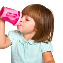 Woman eating and swallowing fruit salad